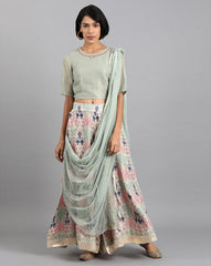 W Women Embroidered Top with Skirt and Drape Dupatta in Sage Green, flowy layered design for festive occasions.